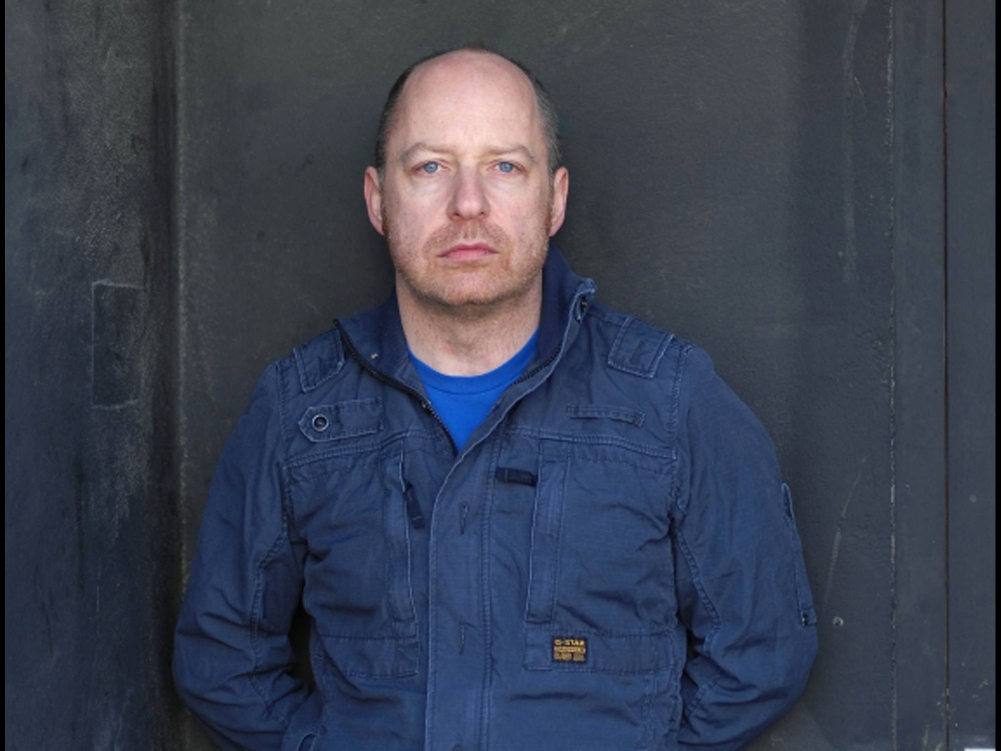 An image of Tim Etchells. He is a white man wearing a blue jacket.