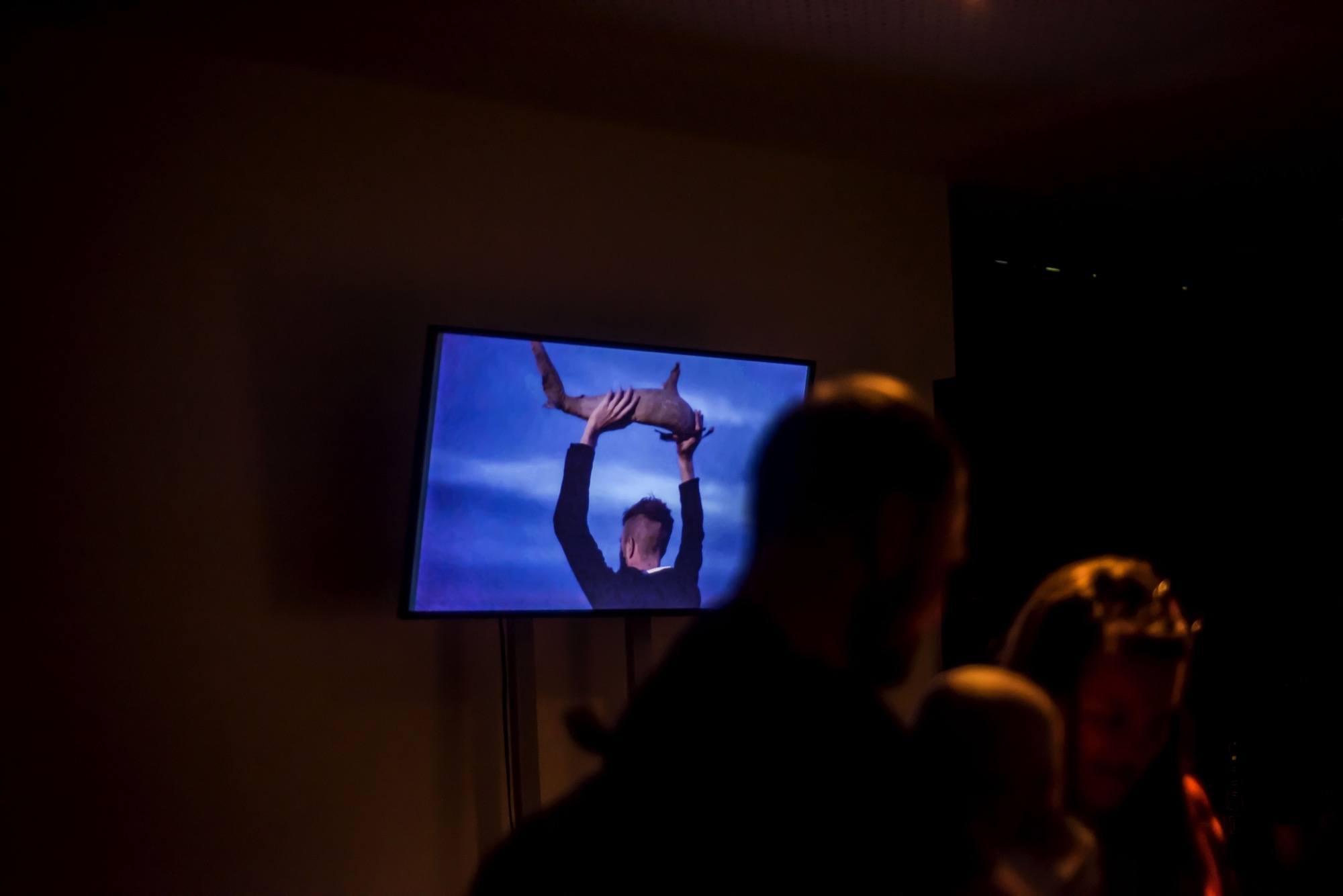 tv screen with person holding a shark