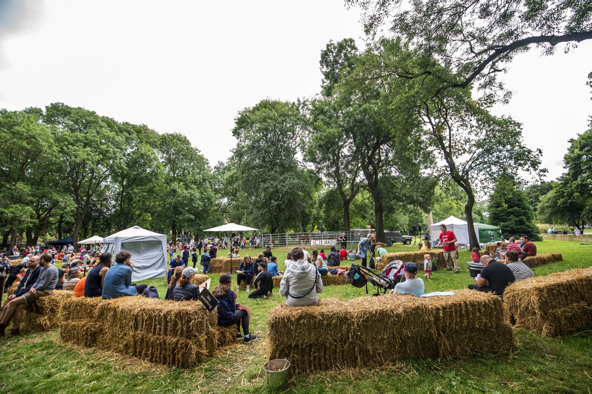 people sitting on hay bales