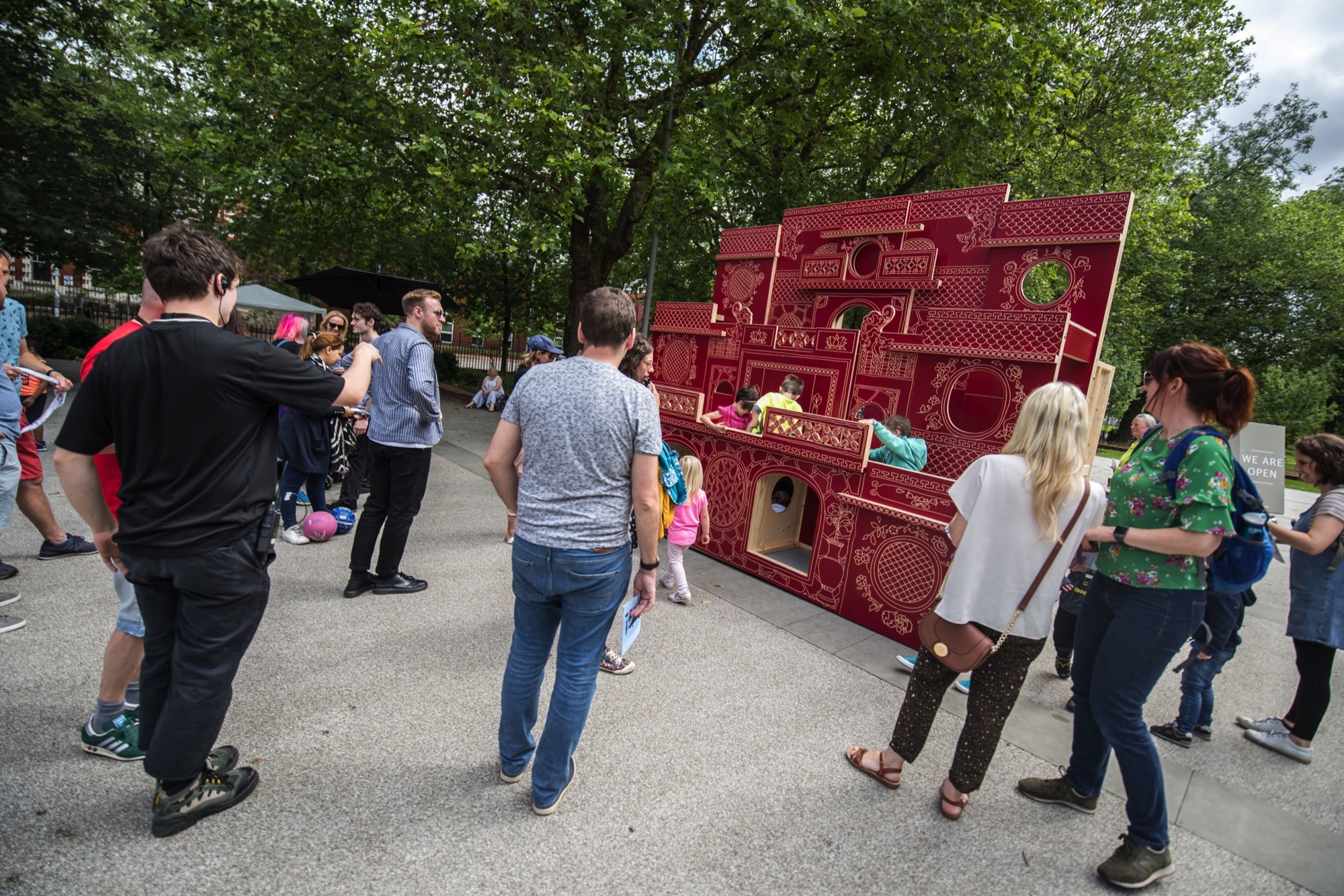 people looking at large 'mouse palace'