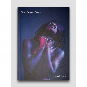 Jamal Gerald, who is a Black man with shoulder length dreadlocks, is in a blue-lit room with his head tilted back whilst dancing. A purple light is lighting up his naked body.