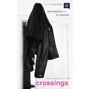 A black leather jacket hanging on the corner of a white door.