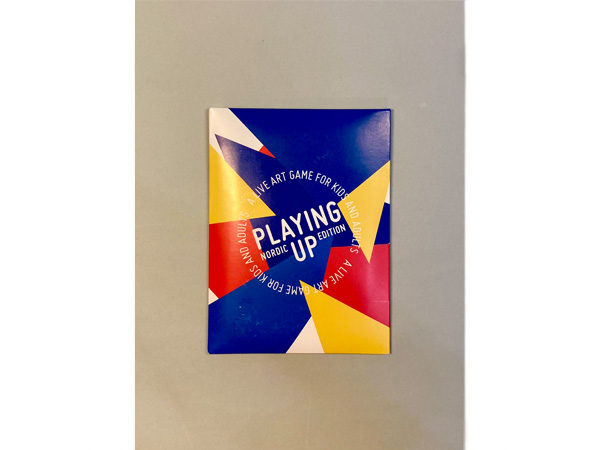 PlayingUpNordic The cover of a thin pack of cards with geometric shapes in blue, yellow and red.